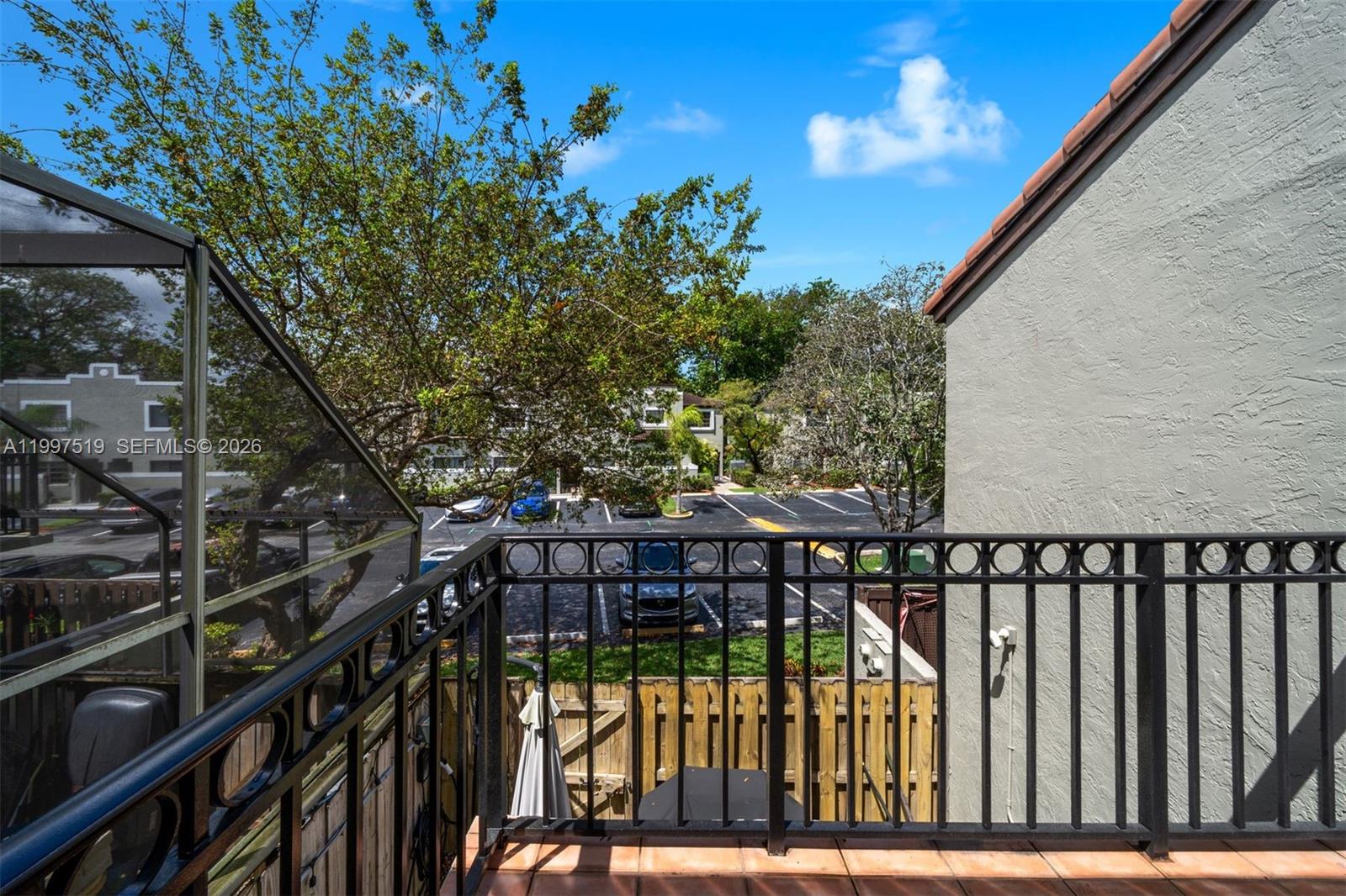 10415 Southwest 154th Court, Unit 2 Miami, FL 33196 - Photo 23 of 27 a view of balcony with wooden floor and fence
