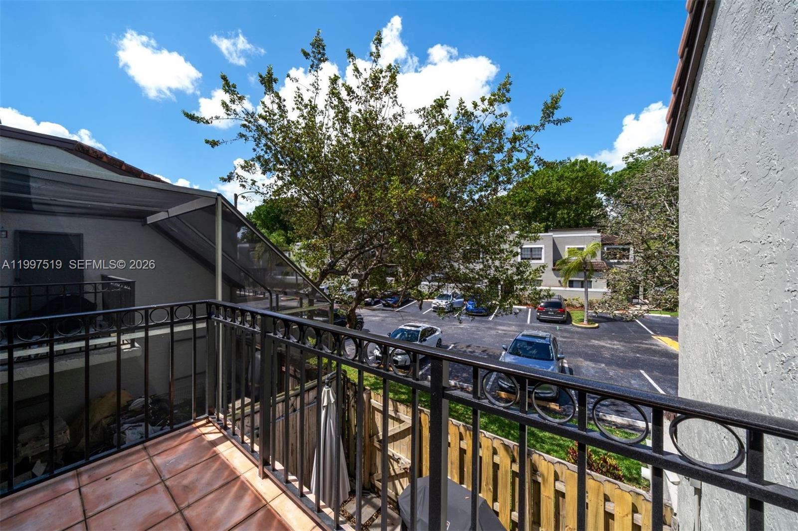 10415 Southwest 154th Court, Unit 2 Miami, FL 33196 - Photo 24 of 27 a view of balcony with wooden floor and outdoor seating