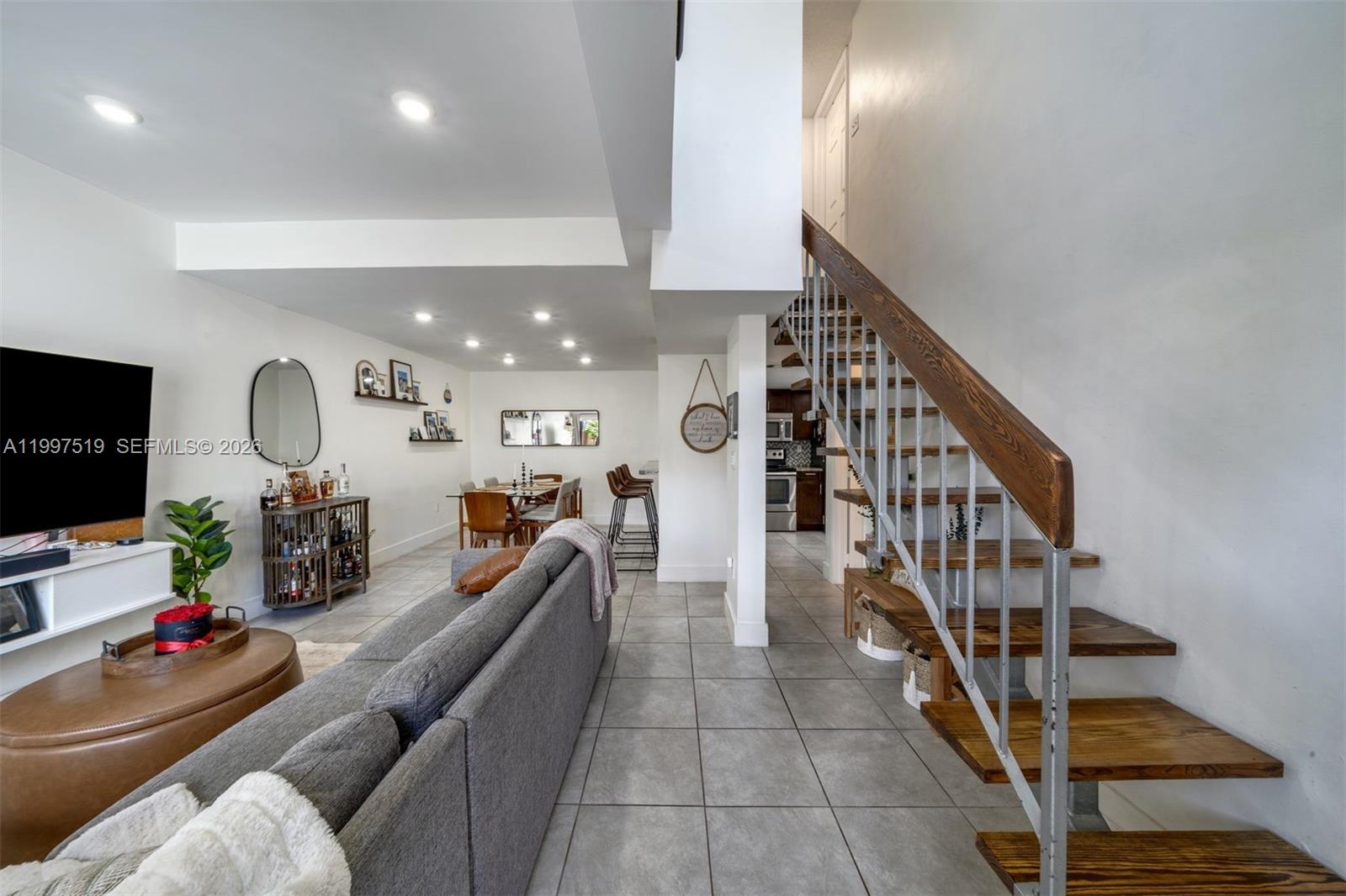 10415 Southwest 154th Court, Unit 2 Miami, FL 33196 - Photo 4 of 27 a living room with furniture and a flat screen tv