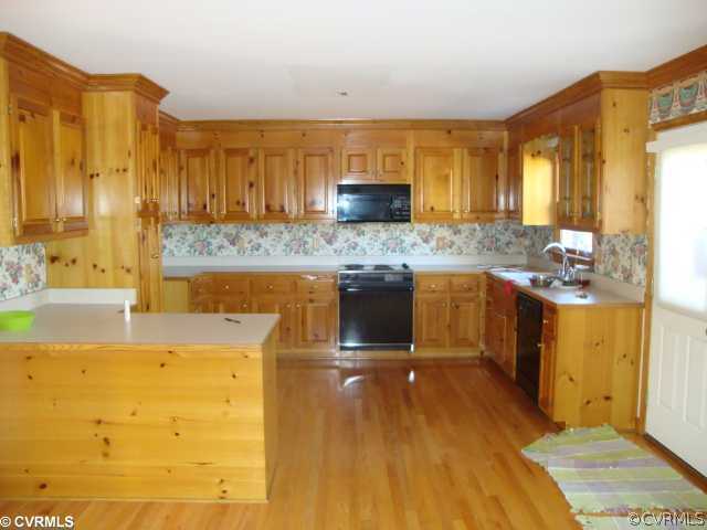 12720 Lilking Road Chester, VA 23831 - Photo 3 of 5 a kitchen with stainless steel appliances granite countertop a sink and cabinets