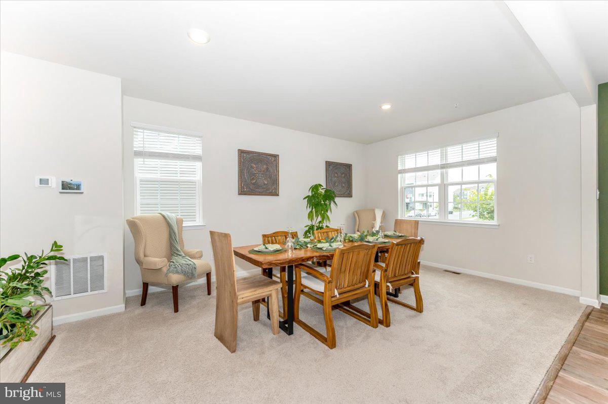 2052 Pomona Way Frederick, MD 21702 - Photo 11 of 71 a view of a dining room with furniture and a potted plant