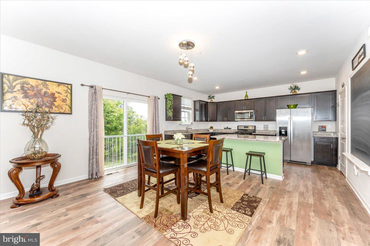 2052 Pomona Way Frederick, MD 21702 - Photo 16 of 71 a view of a dining room with furniture window and wooden floor