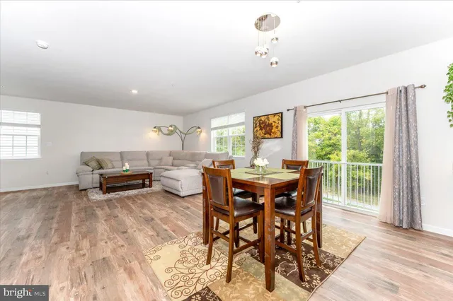 a kitchen with stainless steel appliances granite countertop a refrigerator a sink a stove a microwave and island