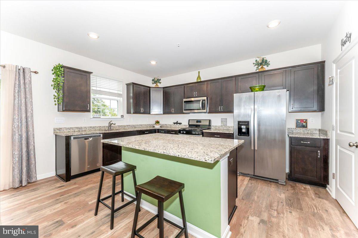 2052 Pomona Way Frederick, MD 21702 - Photo 18 of 71 a kitchen with stainless steel appliances granite countertop a refrigerator a sink a stove a microwave and island