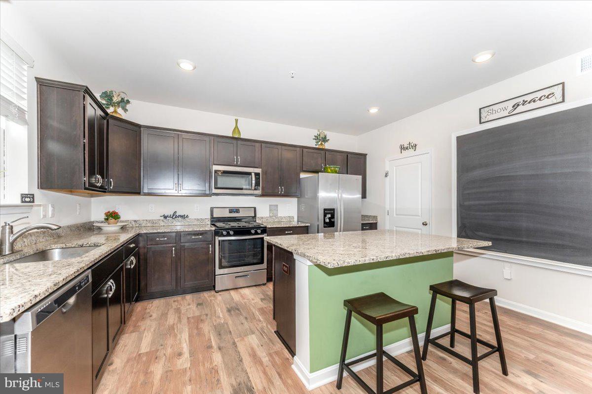 2052 Pomona Way Frederick, MD 21702 - Photo 19 of 71 a kitchen with stainless steel appliances granite countertop a sink stove refrigerator and cabinets