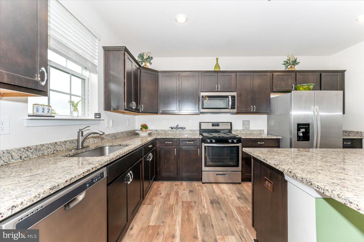 2052 Pomona Way Frederick, MD 21702 - Photo 20 of 71 a kitchen with stainless steel appliances granite countertop a sink stove and refrigerator