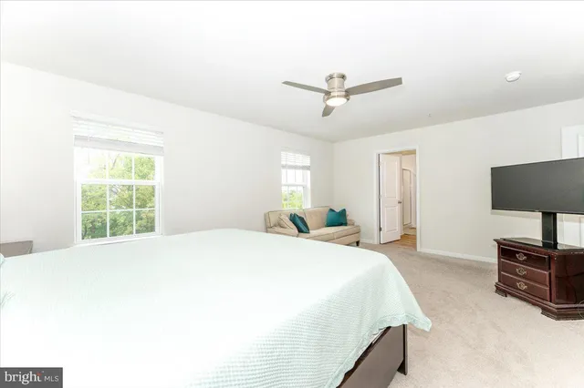 a bedroom with a bed and a mirror