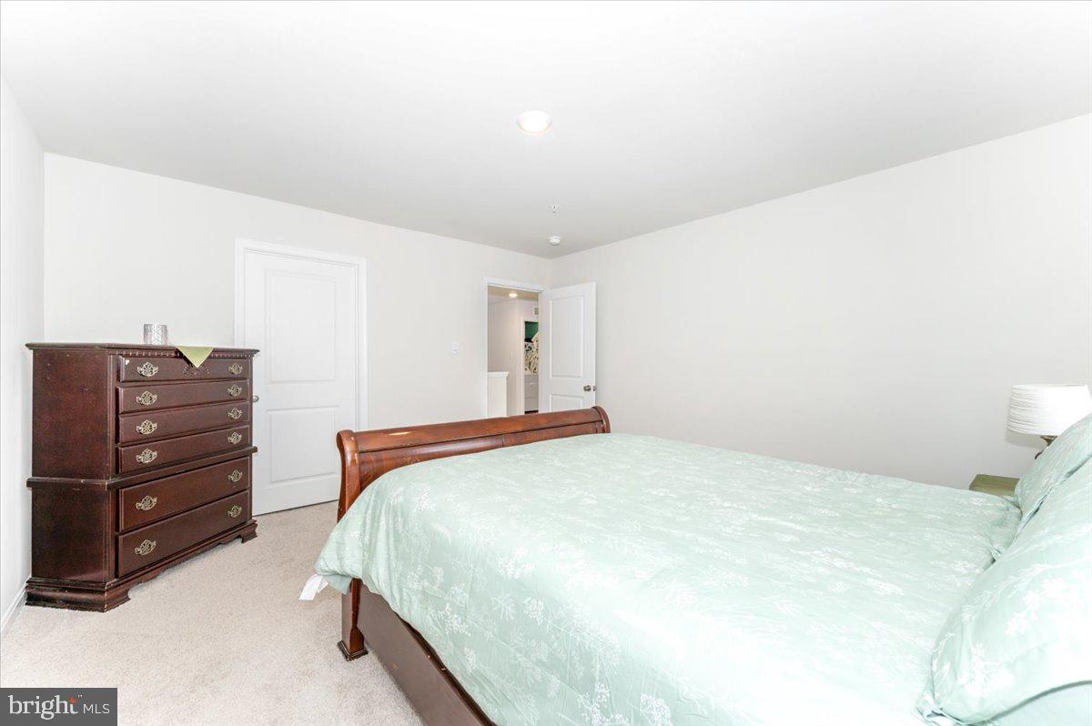 2052 Pomona Way Frederick, MD 21702 - Photo 34 of 71 a bedroom with a bed and a mirror