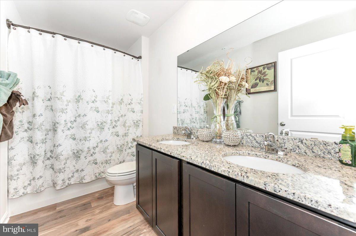 2052 Pomona Way Frederick, MD 21702 - Photo 39 of 71 a bathroom with a granite countertop sink a toilet and a mirror