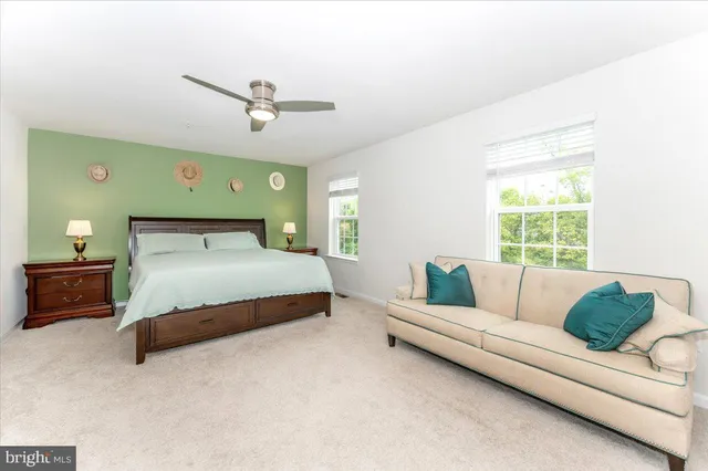 a bedroom with a bed couch and window