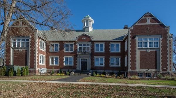 a front view of a residential apartment building with a yard
