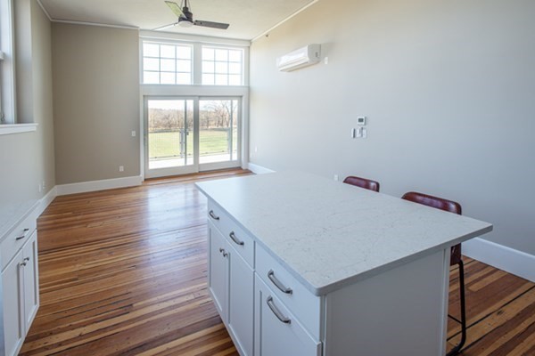 58 Main Street, Unit 4 Hatfield, MA 01038 - Photo 11 of 42 a hallway with a window and wooden floor