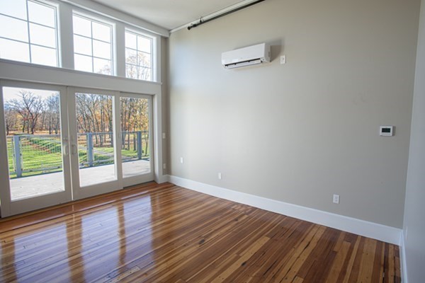 58 Main Street, Unit 4 Hatfield, MA 01038 - Photo 22 of 42 a view of an empty room with wooden floor and a window