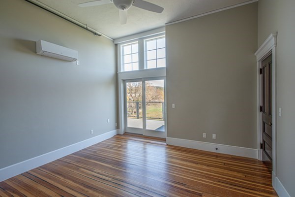58 Main Street, Unit 4 Hatfield, MA 01038 - Photo 25 of 42 an empty room with wooden floor and windows