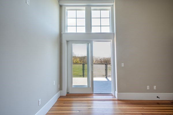 58 Main Street, Unit 4 Hatfield, MA 01038 - Photo 28 of 42 an empty room with wooden floor and windows