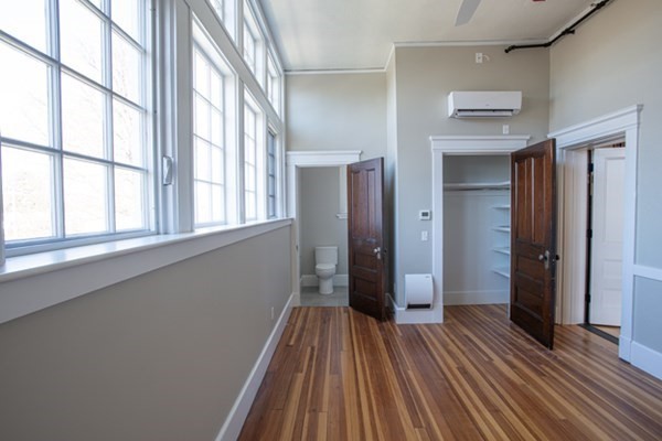 58 Main Street, Unit 4 Hatfield, MA 01038 - Photo 30 of 42 a view of an empty room with wooden floor and a window