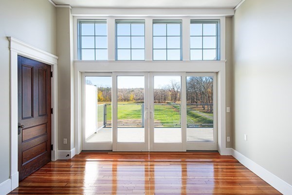 58 Main Street, Unit 4 Hatfield, MA 01038 - Photo 6 of 42 a view of an empty room with wooden floor and a window