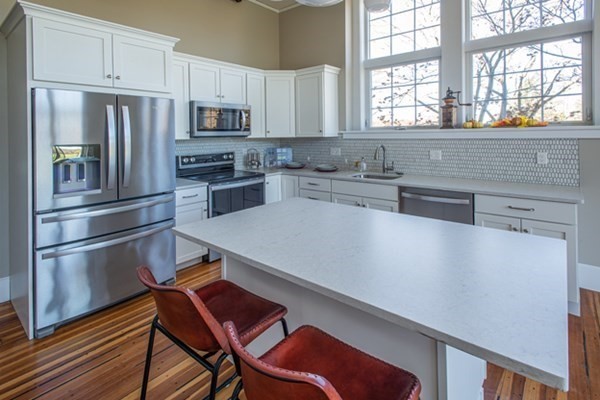 58 Main Street, Unit 4 Hatfield, MA 01038 - Photo 9 of 42 a kitchen with stainless steel appliances a refrigerator sink and microwave