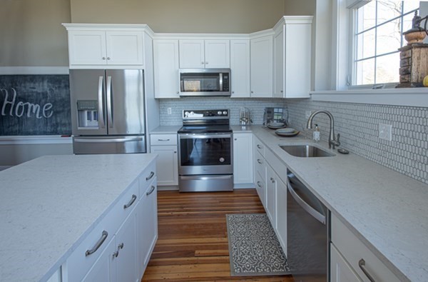 58 Main Street, Unit 4 Hatfield, MA 01038 - Photo 10 of 42 a kitchen with kitchen island granite countertop a sink stainless steel appliances and cabinets