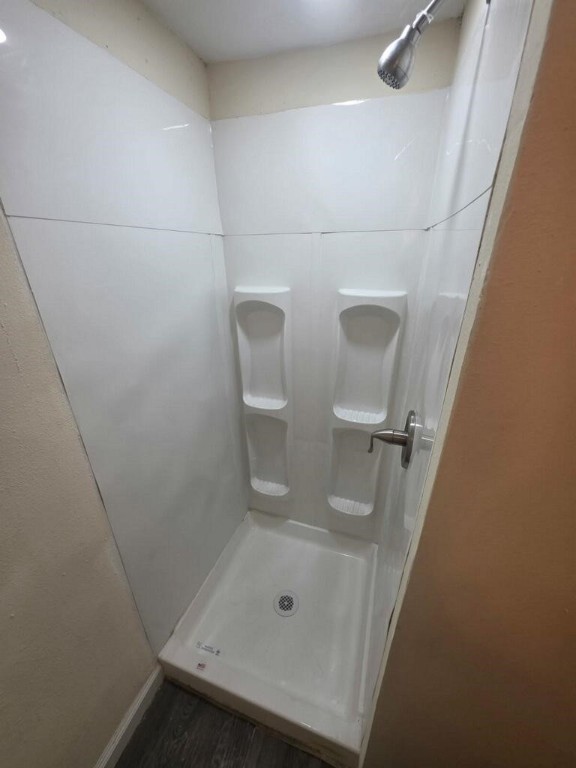 446 Lexington Livingston, TX 77351 - Photo 14 of 14 a bathroom with a glass shower door