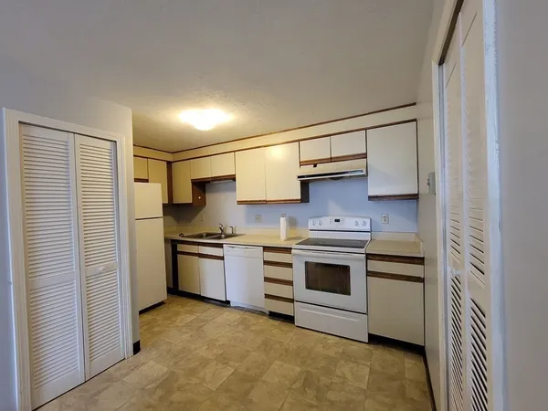 a kitchen with stainless steel appliances granite countertop a stove and a refrigerator