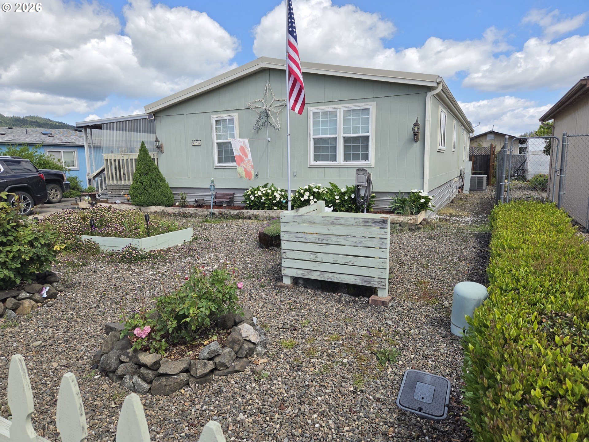 a front view of a house with a yard and potted plants