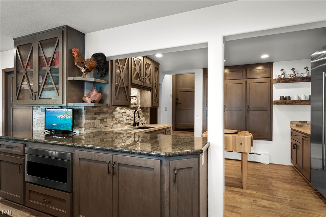 1448 Pittman Terrace Glenbrook, NV 89413 - Photo 22 of 29 a kitchen with stainless steel appliances granite countertop a stove refrigerator and cabinets