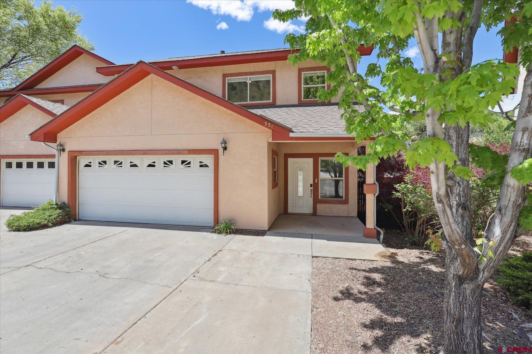 331 Jenkins Ranch Road Durango, CO 81301 - Photo 1 of 35 a front view of a house with a yard and garage