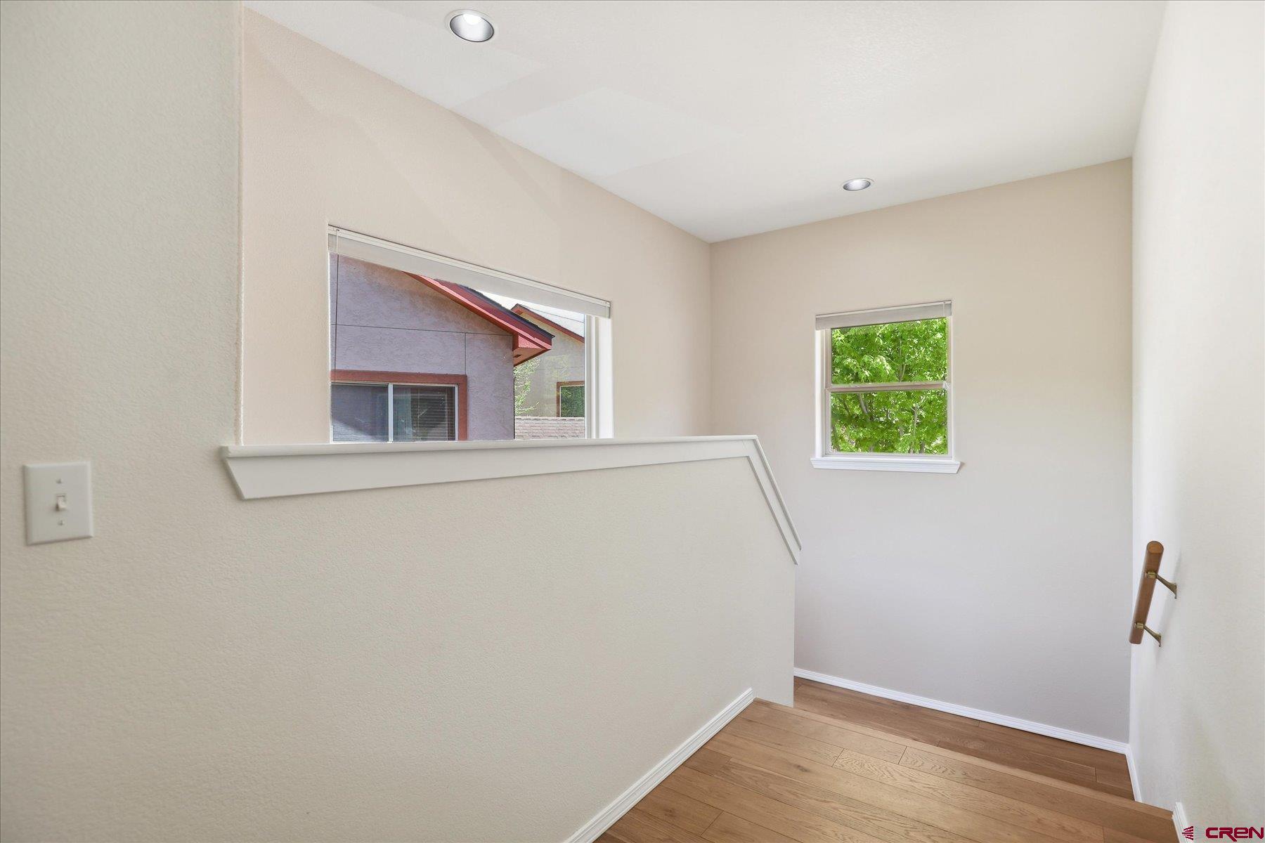 331 Jenkins Ranch Road Durango, CO 81301 - Photo 13 of 35 a view of an empty room with wooden floor and a window