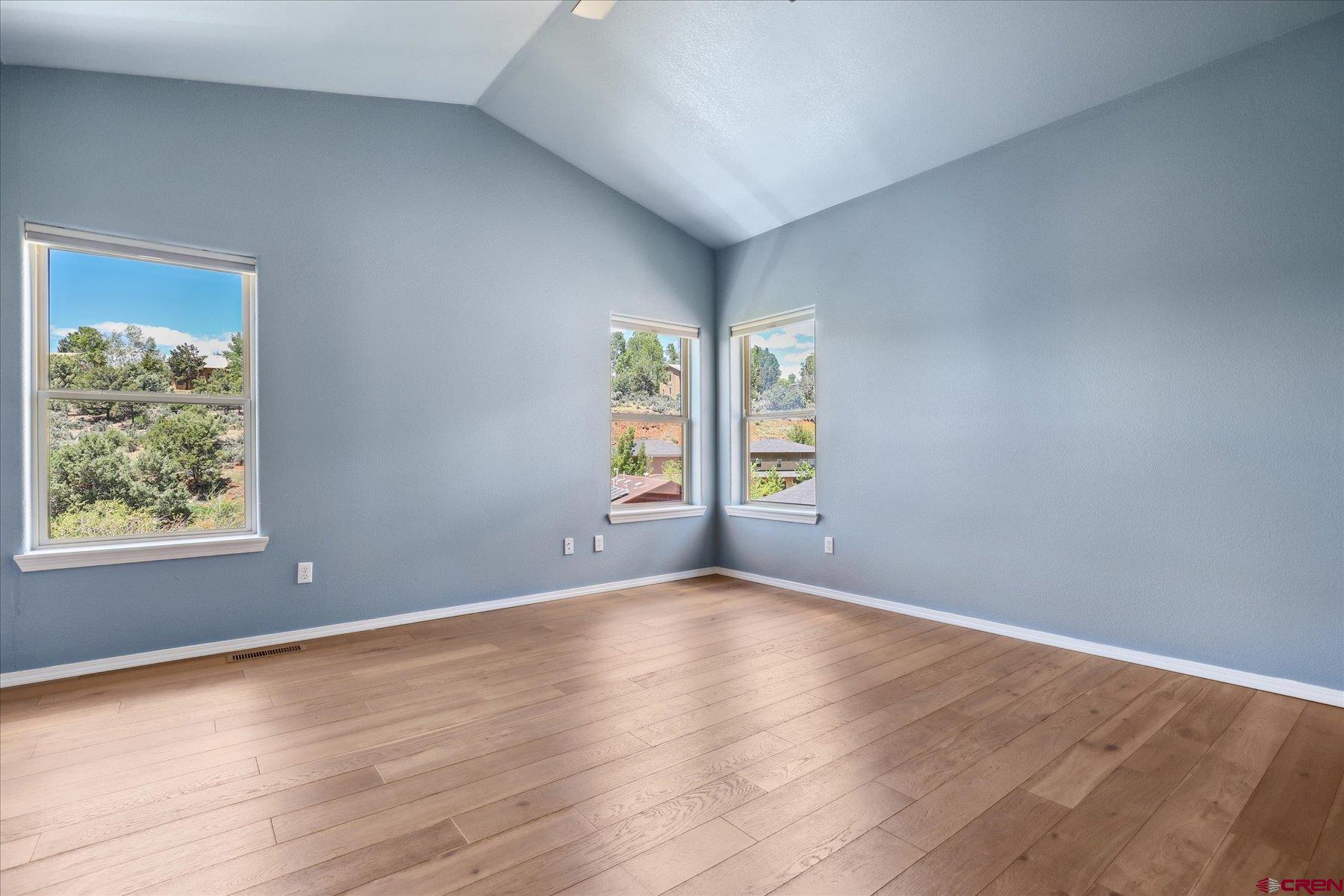 331 Jenkins Ranch Road Durango, CO 81301 - Photo 15 of 35 a view of an empty room with wooden floor and a window
