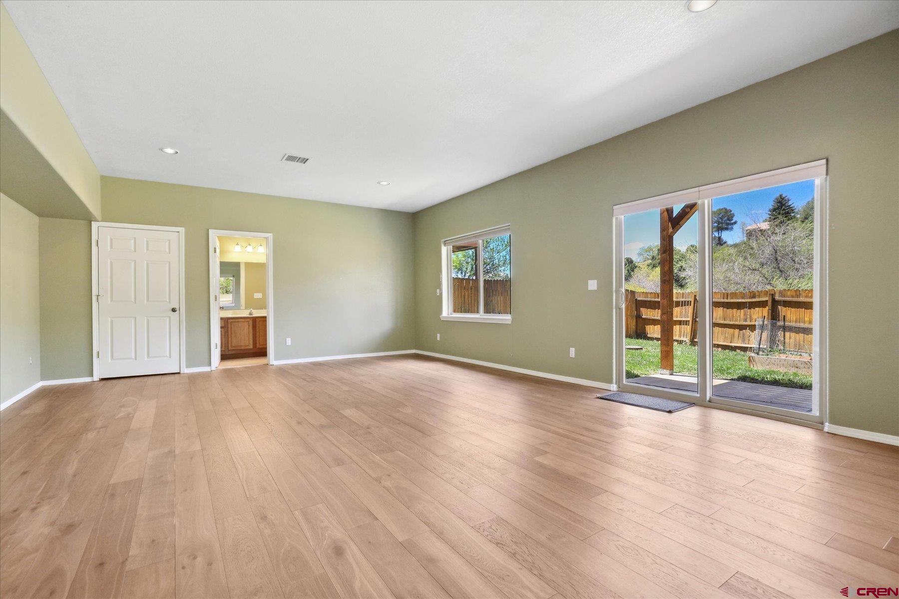 331 Jenkins Ranch Road Durango, CO 81301 - Photo 29 of 35 a view of an empty room with wooden floor and a window