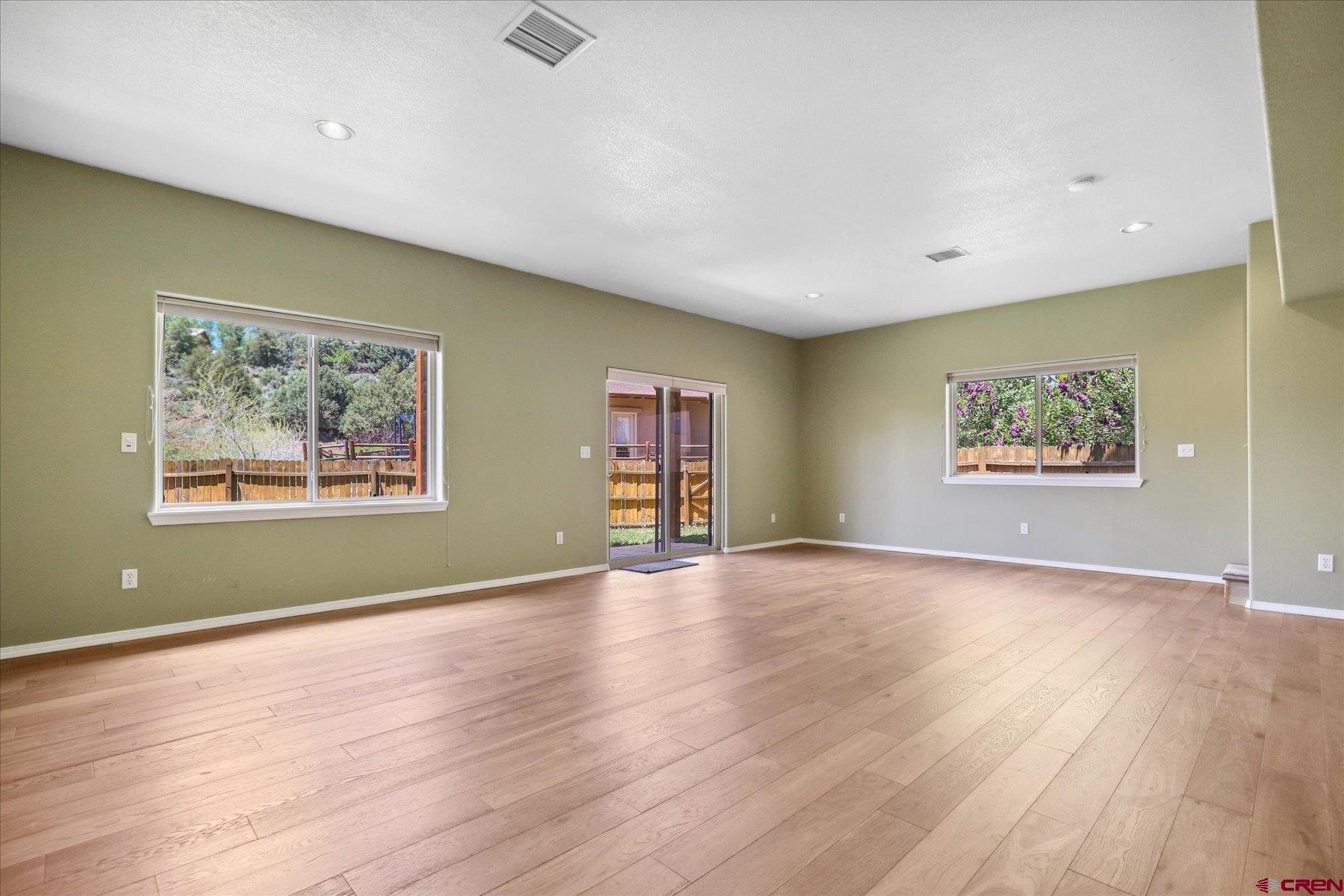 331 Jenkins Ranch Road Durango, CO 81301 - Photo 30 of 35 a view of an empty room with wooden floor and a window