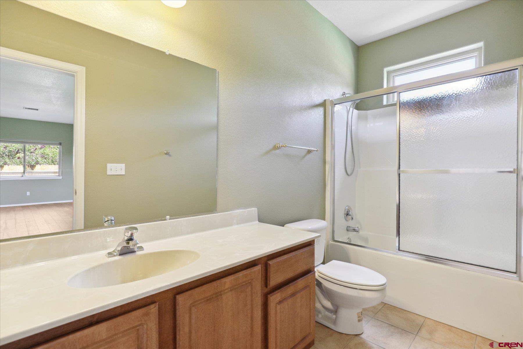 331 Jenkins Ranch Road Durango, CO 81301 - Photo 31 of 35 a bathroom with a granite countertop sink toilet and shower