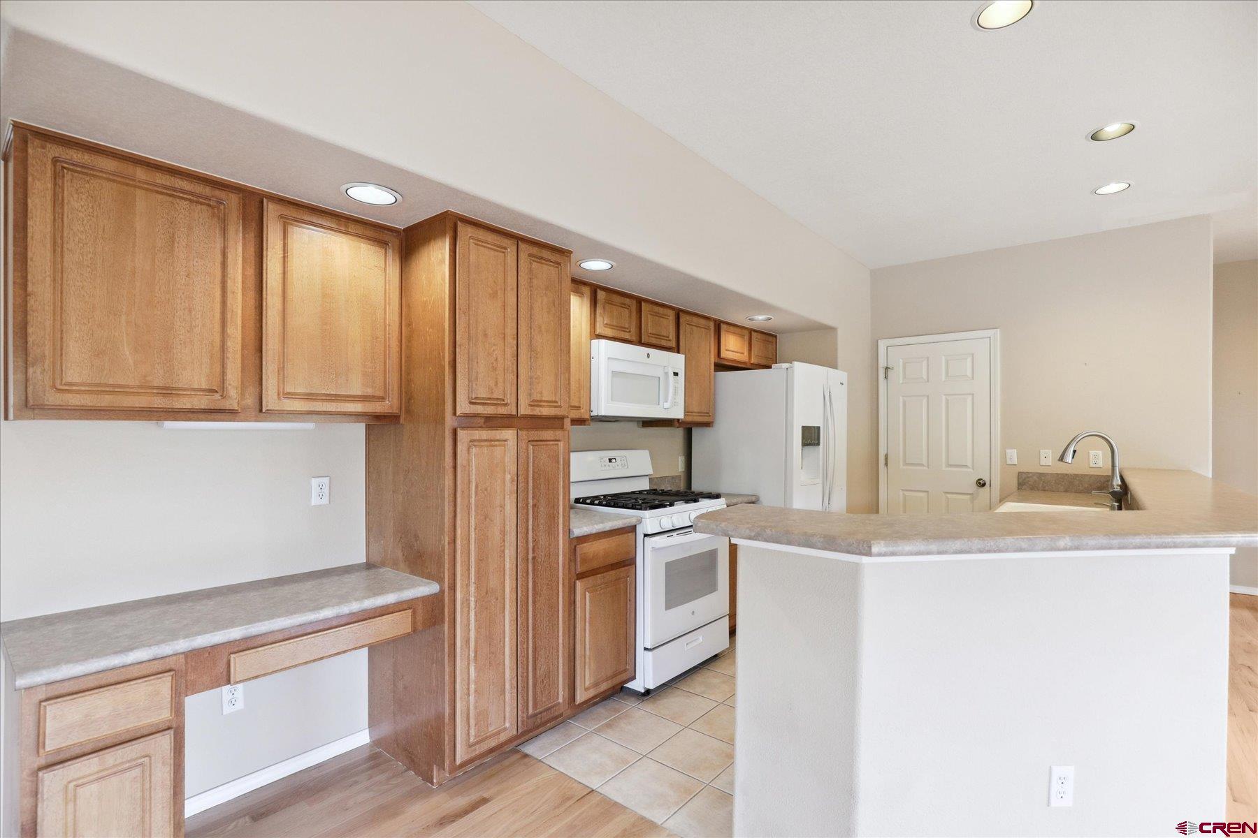 331 Jenkins Ranch Road Durango, CO 81301 - Photo 7 of 35 a kitchen with stainless steel appliances granite countertop a sink and a refrigerator