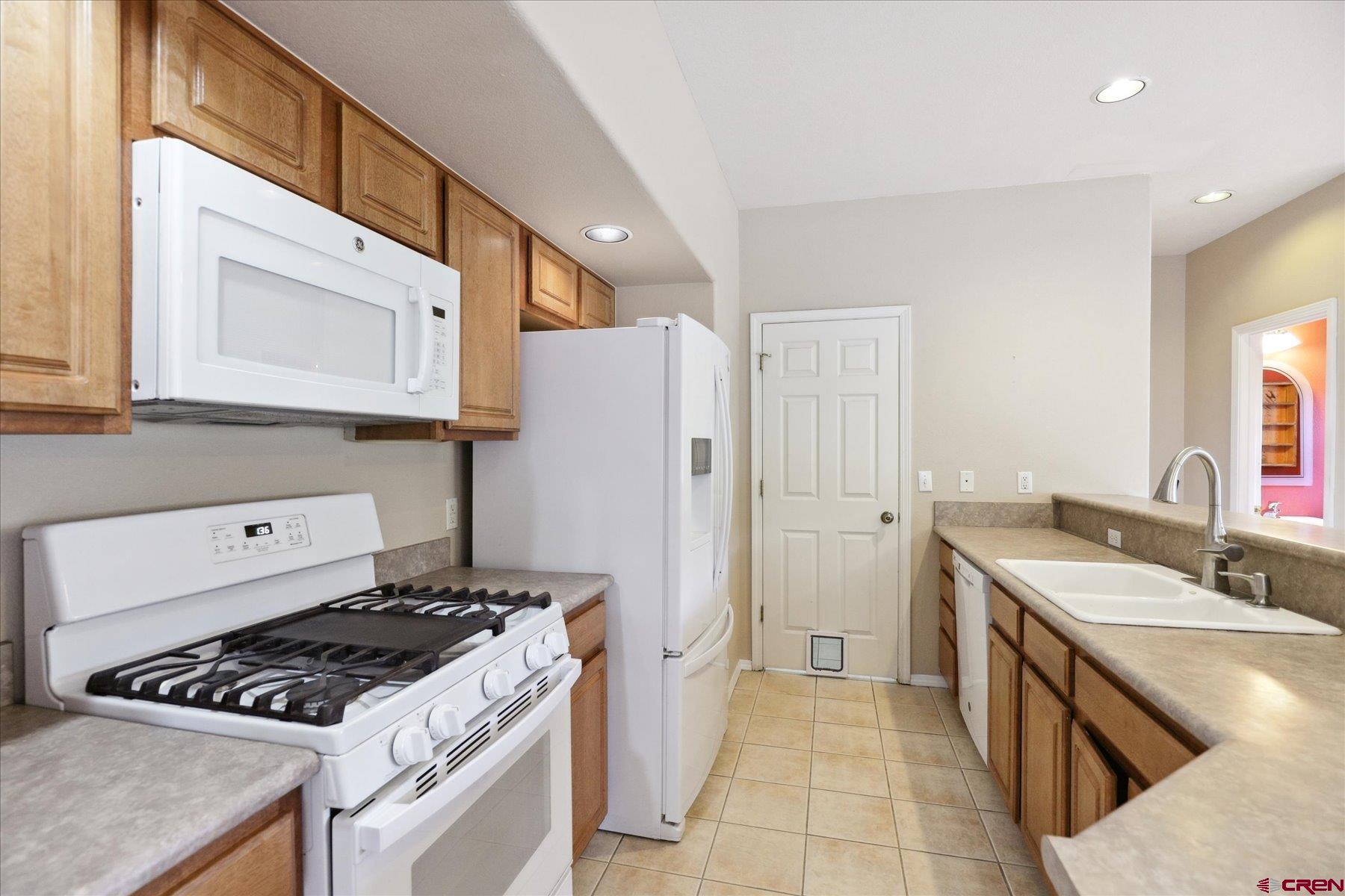 331 Jenkins Ranch Road Durango, CO 81301 - Photo 8 of 35 a kitchen with a stove and a refrigerator