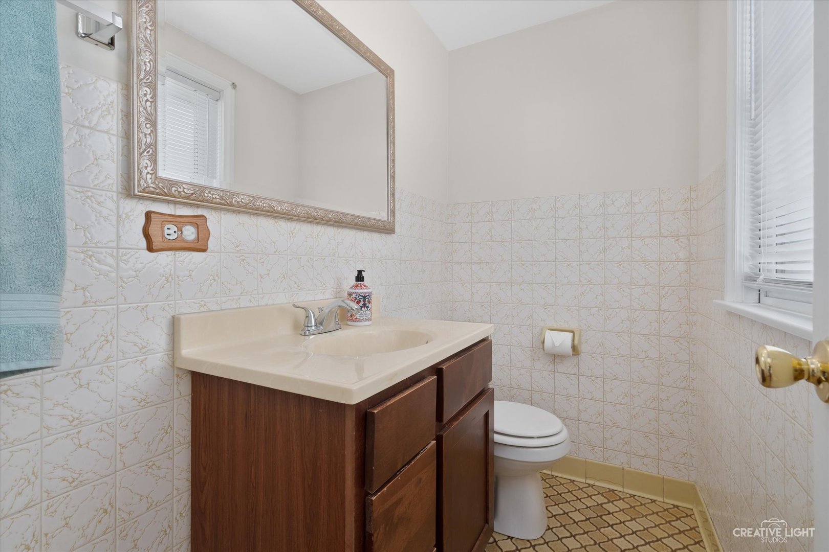 735 East Golf Road Des Plaines, IL 60016 - Photo 13 of 31 a bathroom with a sink a toilet and a mirror