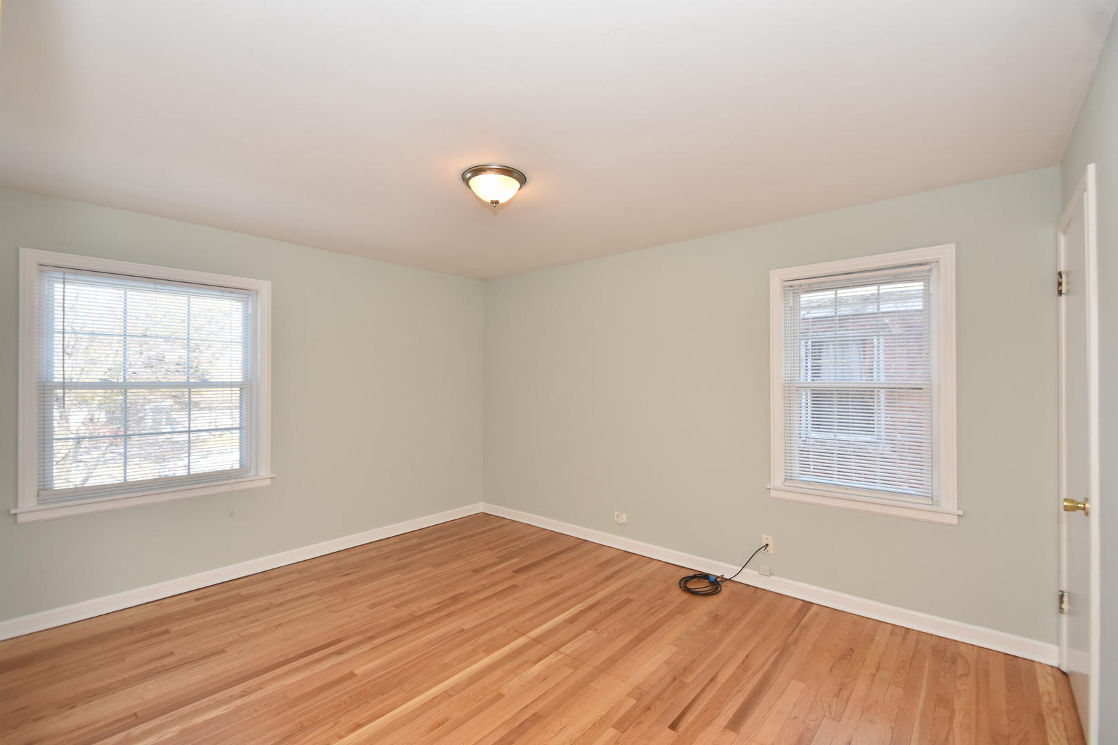 735 East Golf Road Des Plaines, IL 60016 - Photo 15 of 31 an empty room with wooden floor and windows