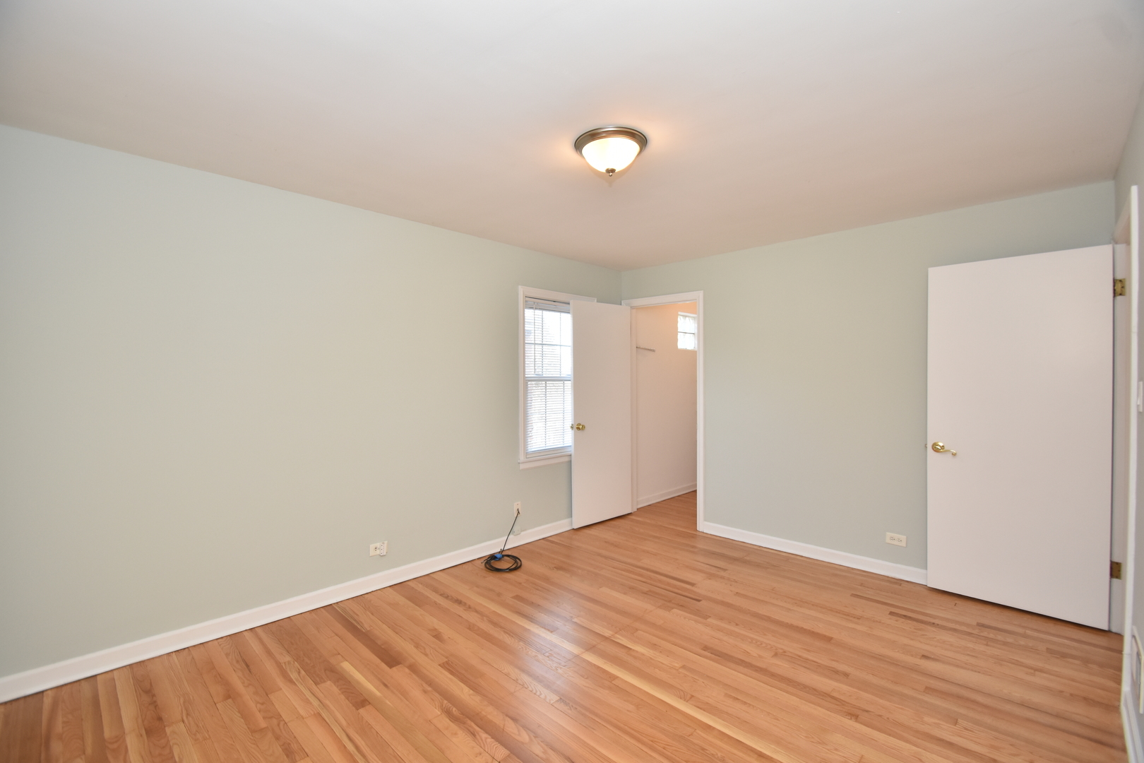 735 East Golf Road Des Plaines, IL 60016 - Photo 16 of 31 an empty room with wooden floor and windows