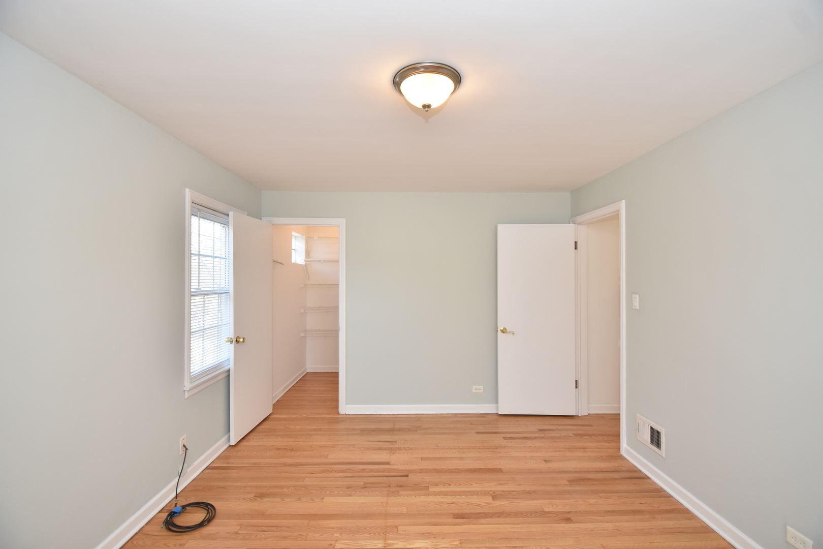 735 East Golf Road Des Plaines, IL 60016 - Photo 17 of 31 a view of an empty room with wooden floor and window