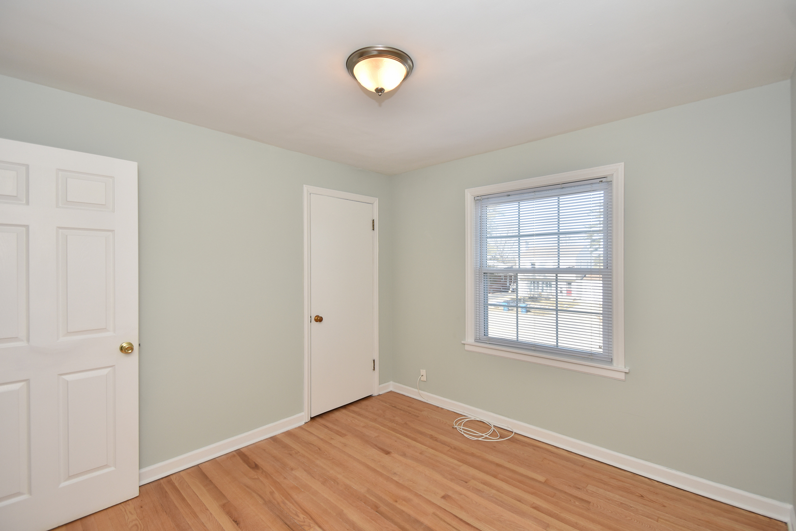 735 East Golf Road Des Plaines, IL 60016 - Photo 19 of 31 an empty room with wooden floor and windows