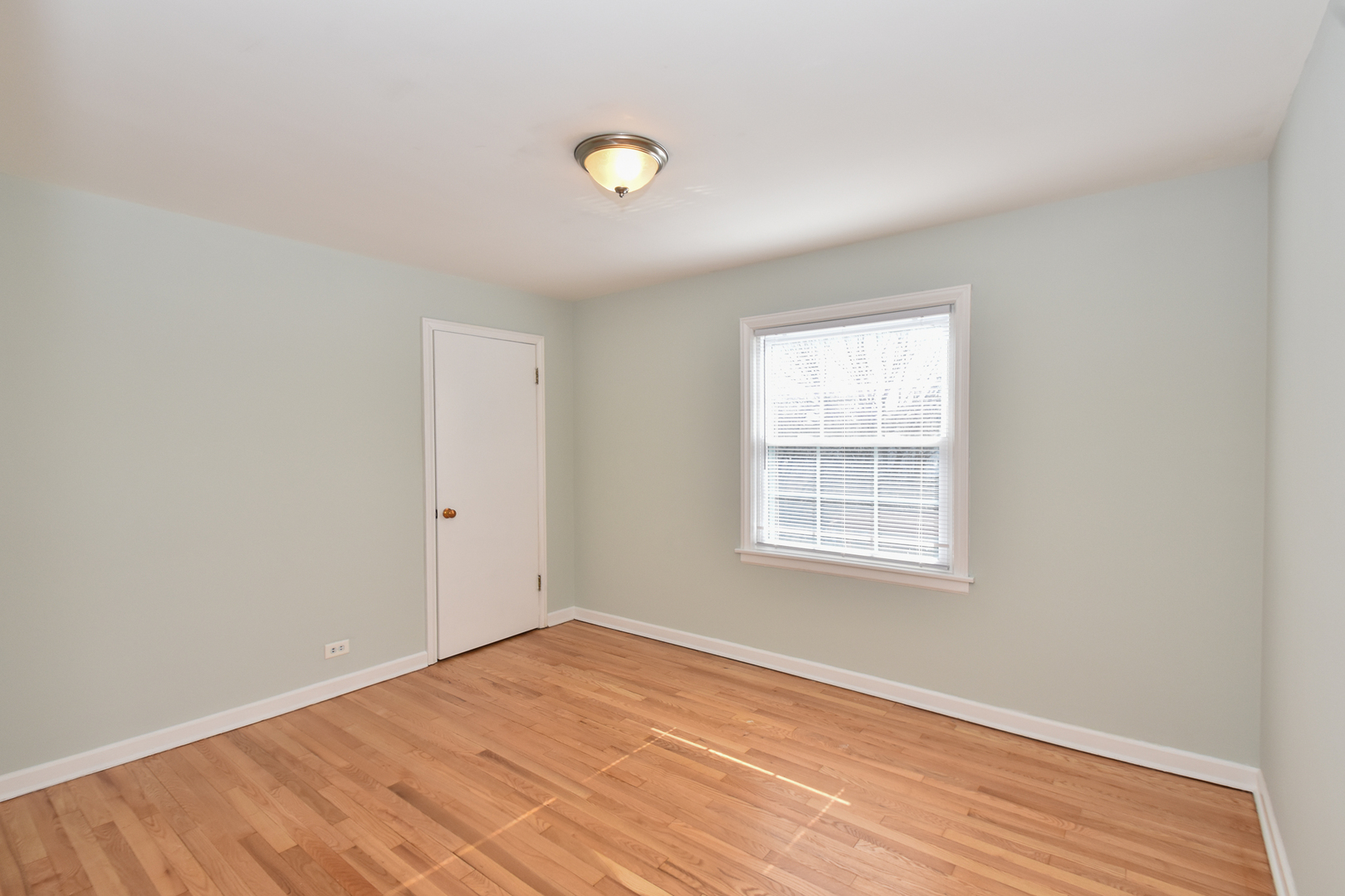 735 East Golf Road Des Plaines, IL 60016 - Photo 21 of 31 an empty room with wooden floor and windows