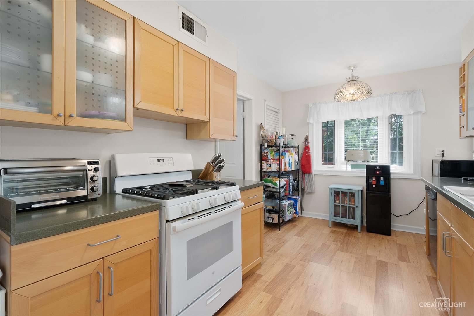 735 East Golf Road Des Plaines, IL 60016 - Photo 9 of 31 a kitchen with a stove a sink and a refrigerator