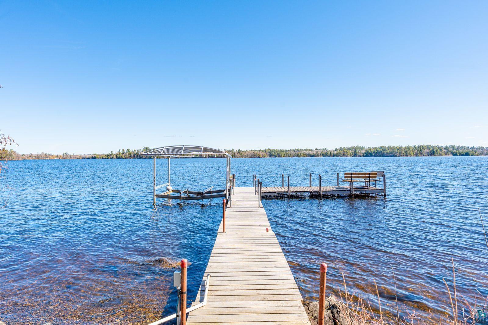 4452 Moccasin Point Road Tower, MN 55790 - Photo 44 of 44 Private wooden dock extending into the water, featuring a built-in bench and an additional boat lift structure