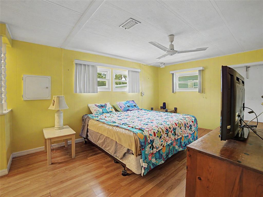 701 Sugar Palm Street Largo, FL 33770 - Photo 13 of 35 a bedroom with a bed and a flat screen tv