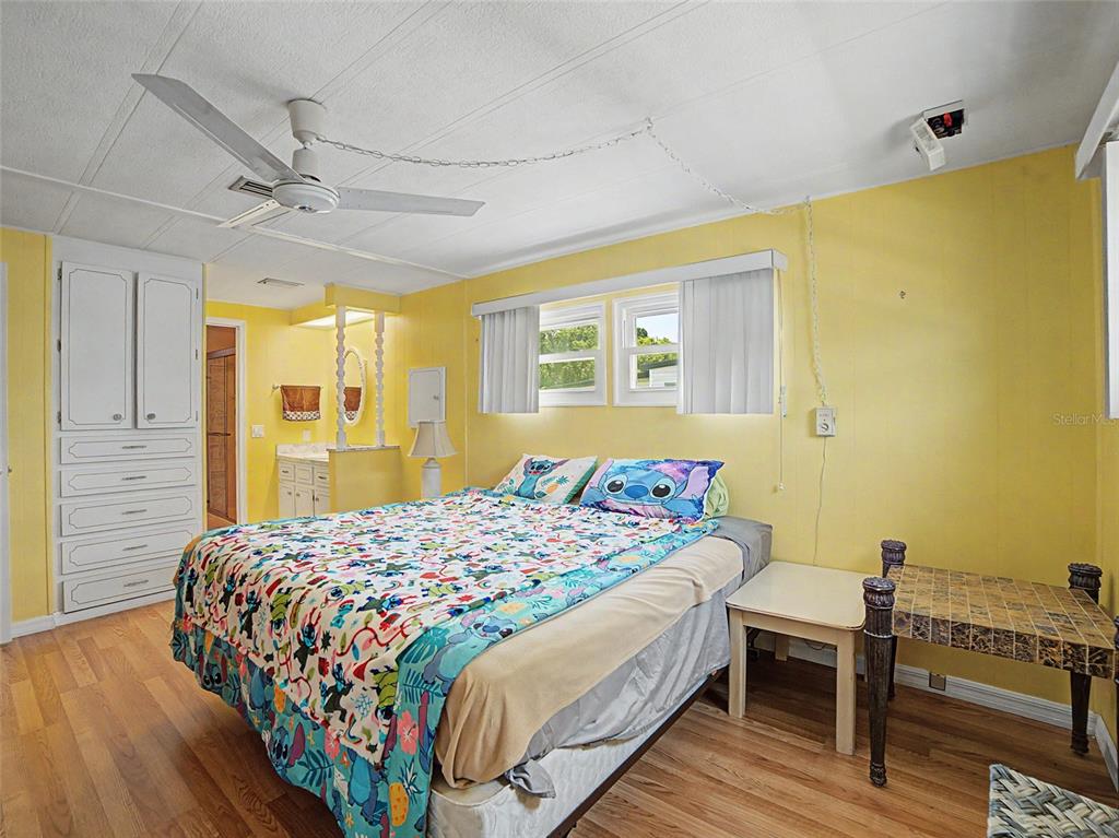 701 Sugar Palm Street Largo, FL 33770 - Photo 14 of 35 a bedroom with a bed and wooden floor