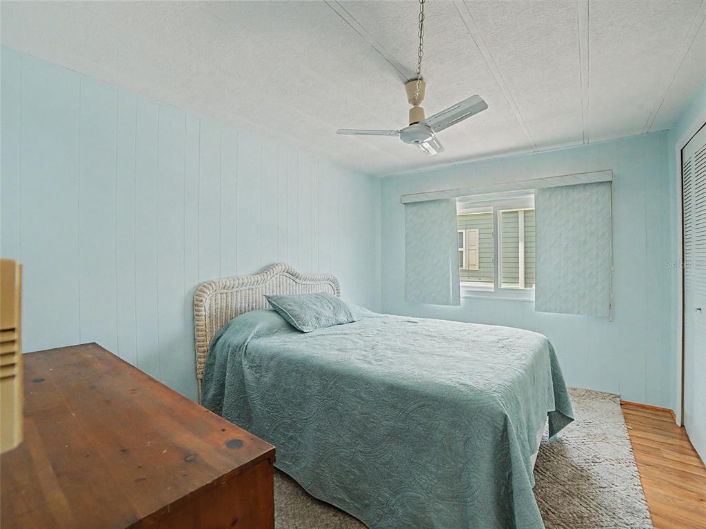 701 Sugar Palm Street Largo, FL 33770 - Photo 16 of 35 a bedroom with a bed and a chandelier