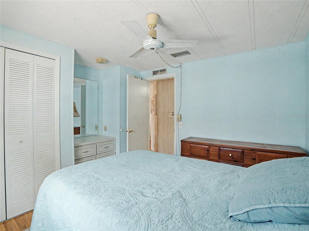 701 Sugar Palm Street Largo, FL 33770 - Photo 17 of 35 a bedroom with a bed and a chandelier