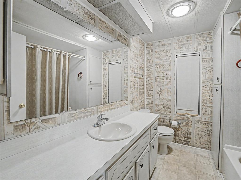701 Sugar Palm Street Largo, FL 33770 - Photo 18 of 35 a bathroom with a sink toilet and shower