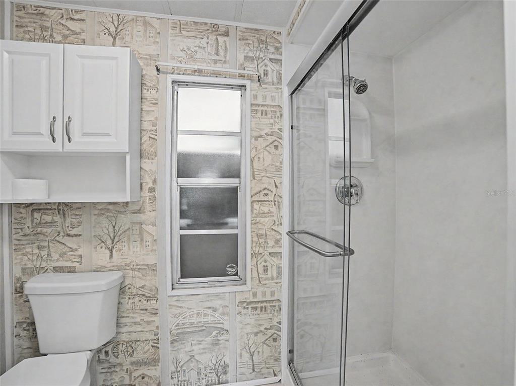 701 Sugar Palm Street Largo, FL 33770 - Photo 19 of 35 a bathroom with a toilet and shower