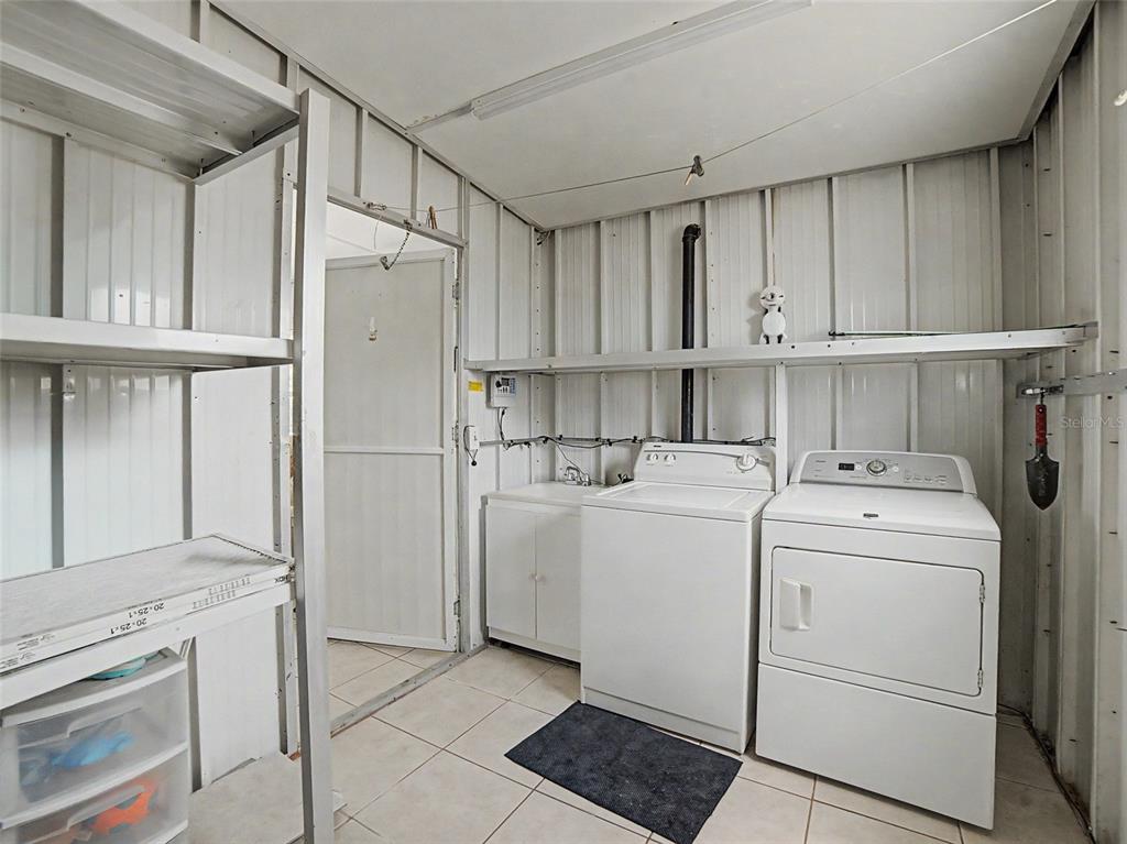 701 Sugar Palm Street Largo, FL 33770 - Photo 24 of 35 a view of kitchen with refrigerator and cabinets